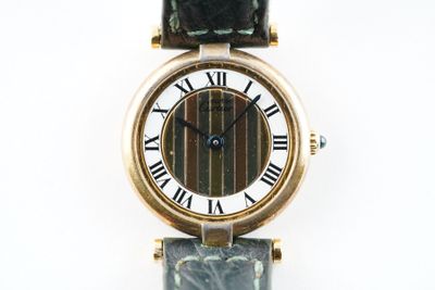 une image d'un gros plan d'une montre-bracelet avec des chiffres romains
