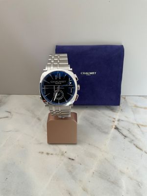 a close up of a watch on a stand on a marble surface