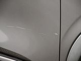a close up of a car ' s front door with scratches on it