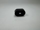 a small black object sitting on a white surface