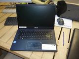 a laptop computer sitting on a wooden desk next to a keyboard and mouse