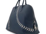 a blue leather handbag with white stitching on the side