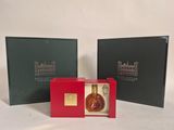 two boxes with a bottle of liquor inside of them on a white surface