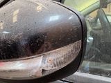 a black car with a mirror on the side of it