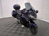 a blue motorcycle that is parked on a checkered floor