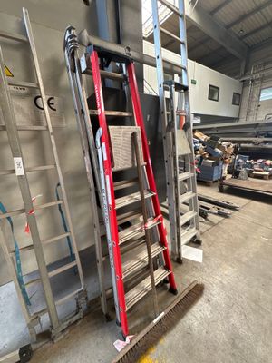 a ladder that is leaning against a wall in a warehouse