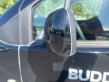 a reflection of a building in the side mirror of a car