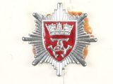silver and red badge with a crown on top of a piece of bread