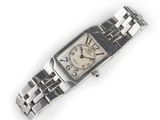 a silver wrist watch with a white face on a white surface