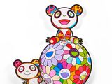 a close up of a panda bear sitting on top of a colorful ball