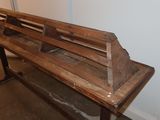 a wooden bench that is sitting in a room