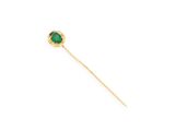 a close up of a gold stick with a green stone on it