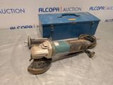 an old electric tool sitting on top of a table next to a box