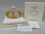an image of a perfume bottle in a box with a tag