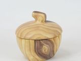 an apple shaped wooden box sitting on top of a white surface