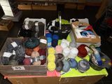 many balls of yarn in a box on the floor