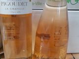 two bottles of wine sitting next to each other on a table