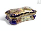 a blue and gold box with a painting on it