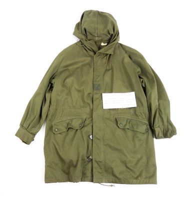 a green parka with a white tag on the chest