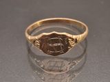 an image of a gold signet ring with a monogram on it