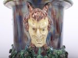 a vase with a picture of a man with horns on it