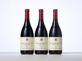 three bottles of wine sitting on top of a table next to each other