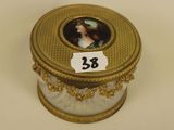 a gold box with a picture of a woman on it