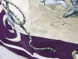 a purple and white scarf with a picture of a man on a horse
