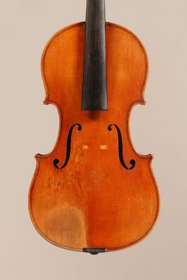 an old violin with a bow hanging from the back