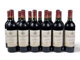 six bottles of wine are lined up in a row on a white surface