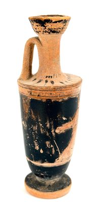 a black and white vase sitting on a white surface