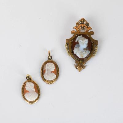 three pieces of jewelry including a broochee, a cameo, and a pendant