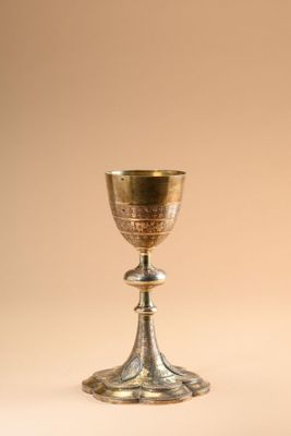 a silver cup sitting on top of a table