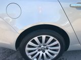 a close up of a car ' s wheel and tire on the street