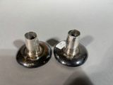 pair of silver plated candlesticks with tags on them