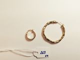 two pairs of gold hoop earrings and a pair of gold hoop earrings