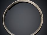 a close up of a silver bracelet with a black background
