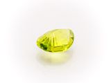 a close up of a yellow diamond on a white surface