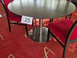a table and chairs in a room with a red carpet