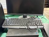 two computers and a laptop sitting on a table