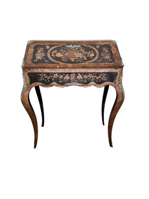 an image of a small wooden table with a black and gold decoration