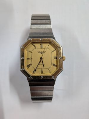 a silver and gold watch with roman numerals on it