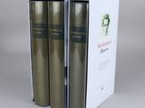 two books in a white box on a gray surface