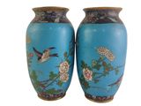 two blue vases with birds and flowers on them