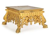 a gold table with a marble top on a white background