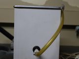 a white box with a yellow handle on a table