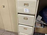 a file cabinet with a bunch of files on top of it