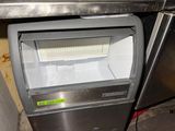 an image of a stainless steel ice maker with a glass door