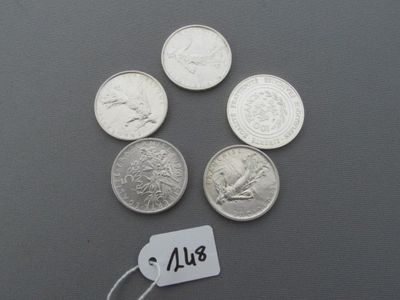 quatre pièces d'argent de 25 cents avec une étiquette de prix sur un fond gris