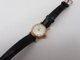 a close up of a wrist watch on a white surface